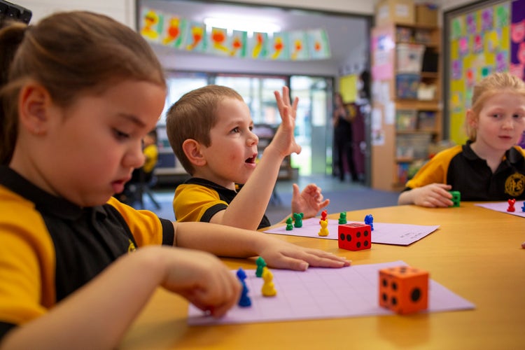 Students working at table in classroom