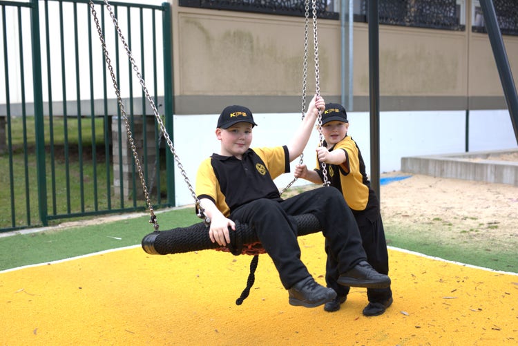 two students playing on swing