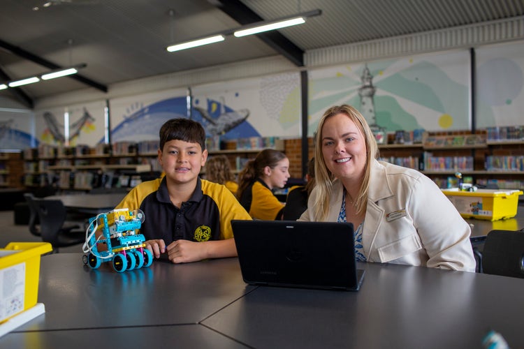 student and teacher with LEGO robotics